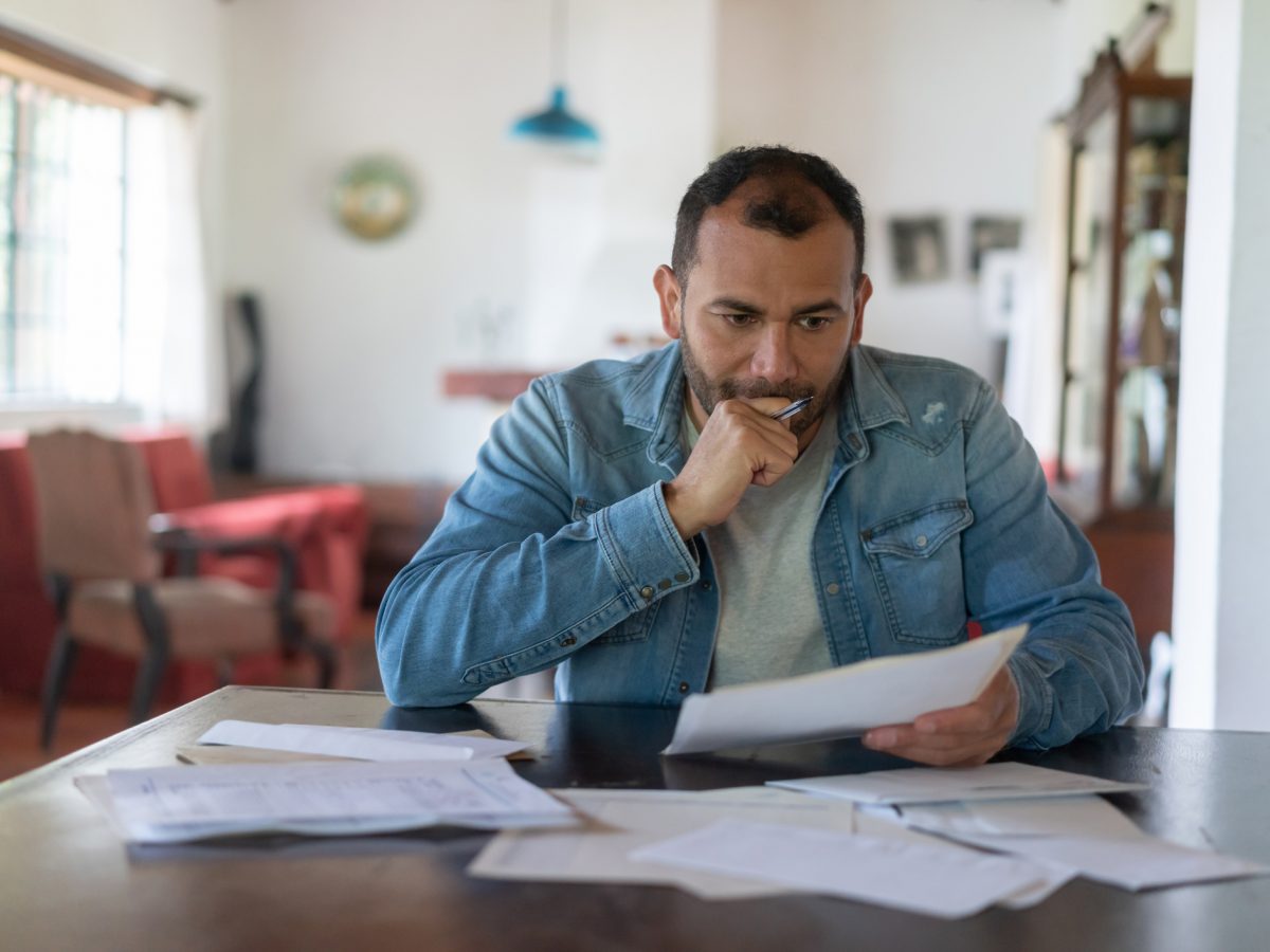 Low income man checking his home finances and looking worried